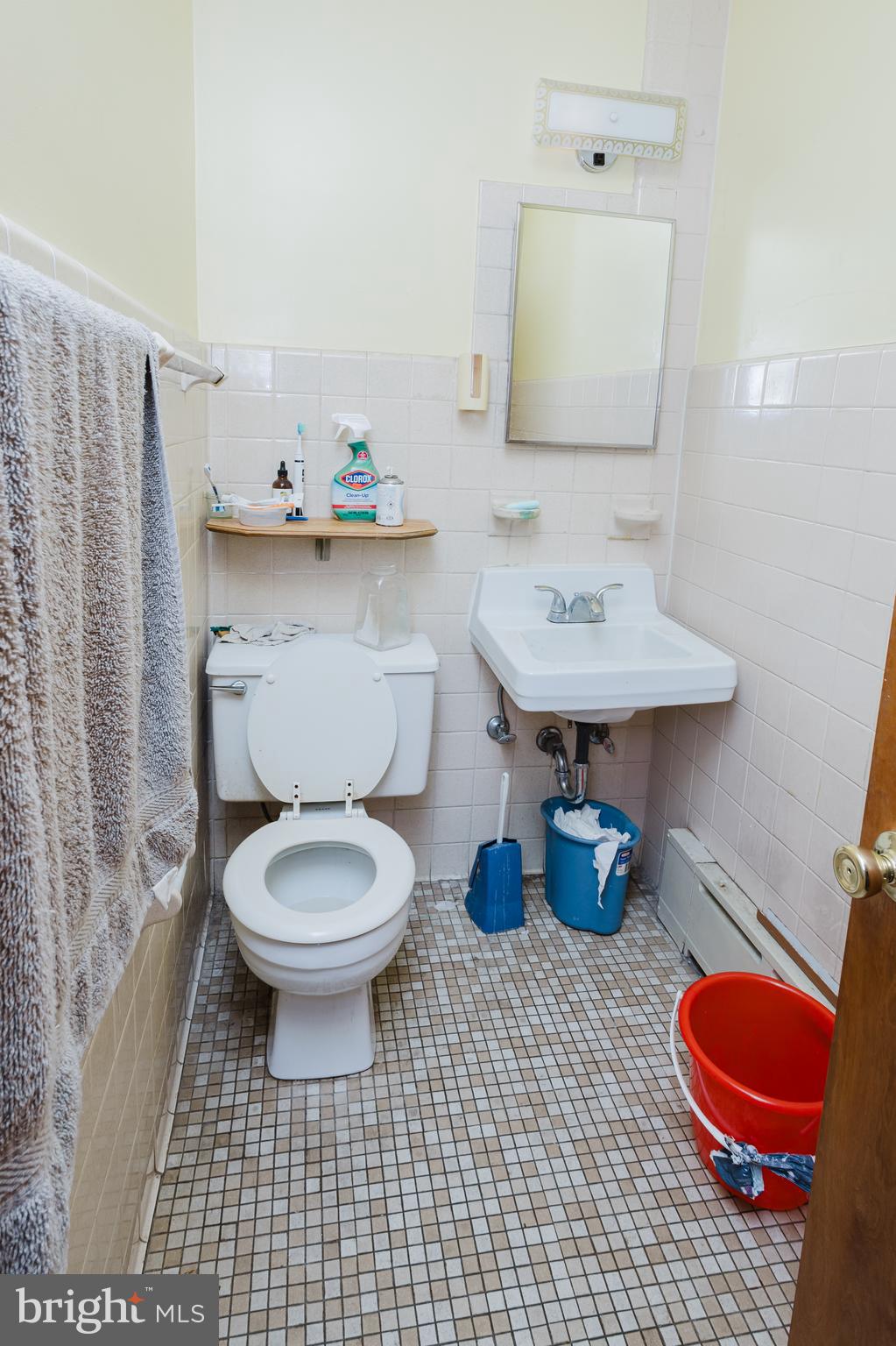 2318 South Broad Street Philadelphia, PA 19145 - Photo 16 of 28 a bathroom with a sink a toilet and a mirror