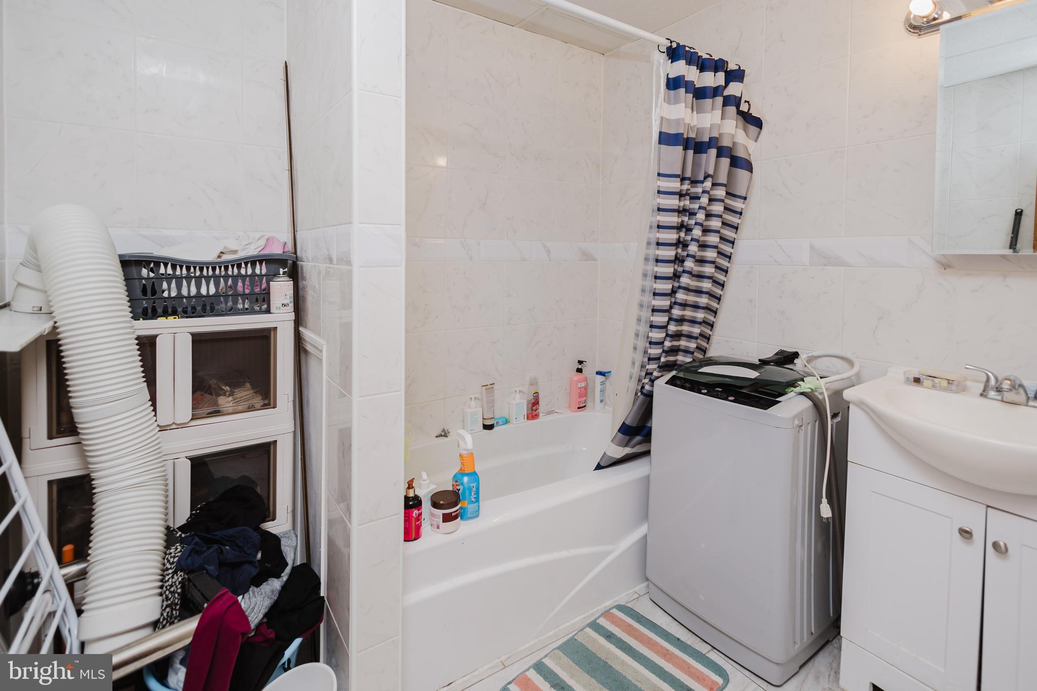 2318 South Broad Street Philadelphia, PA 19145 - Photo 17 of 28 a bathroom with a bathtub and a sink