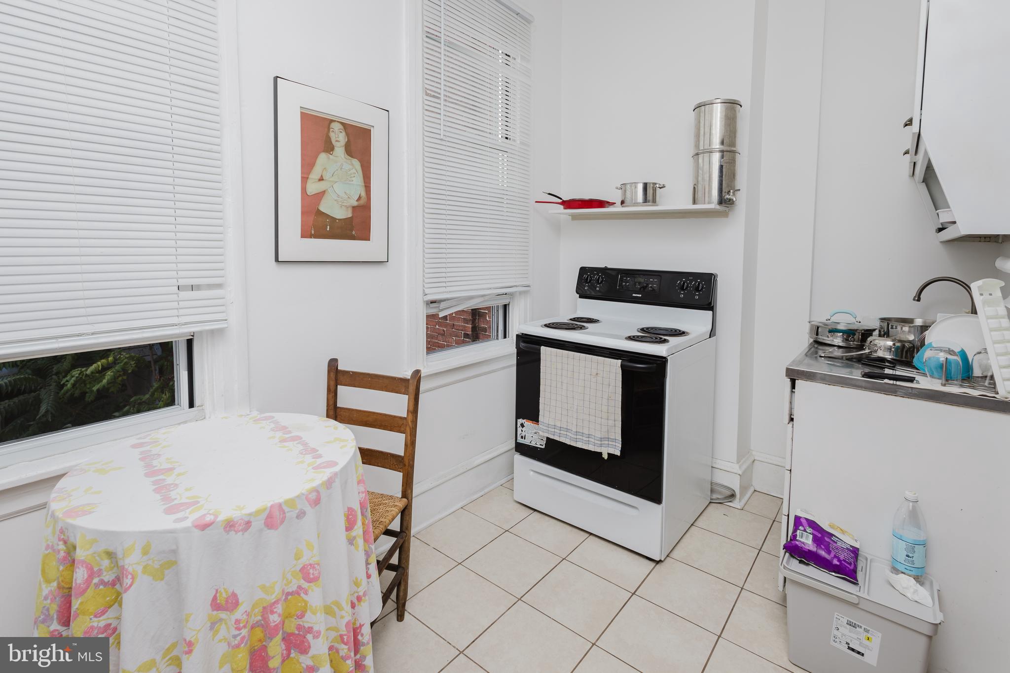 2318 South Broad Street Philadelphia, PA 19145 - Photo 20 of 28 a kitchen with stainless steel appliances a stove a microwave and cabinets
