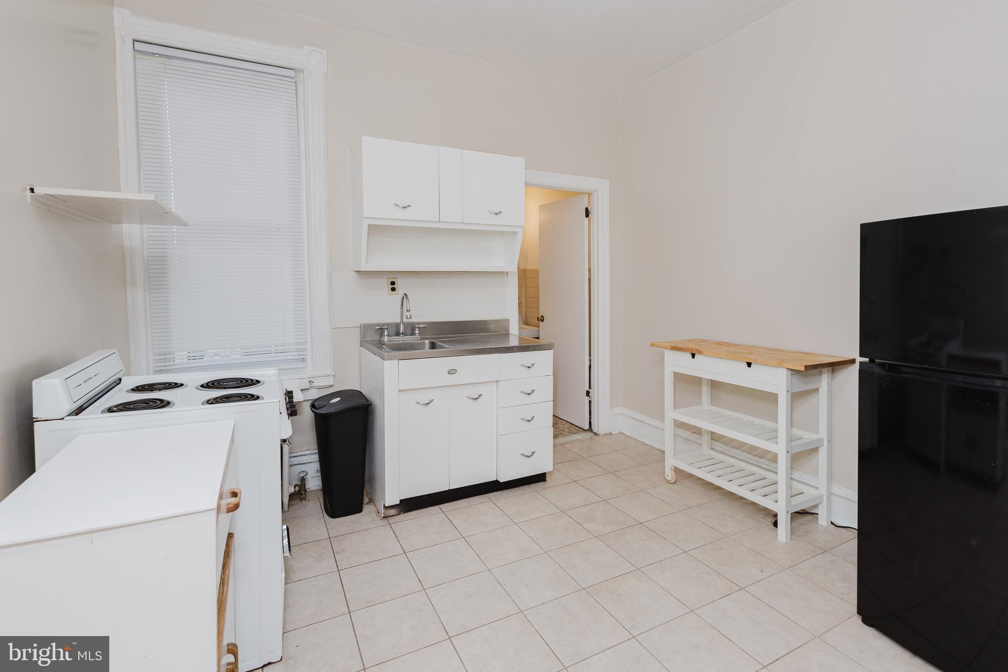 2318 South Broad Street Philadelphia, PA 19145 - Photo 21 of 28 a kitchen with a stove oven and white cabinets