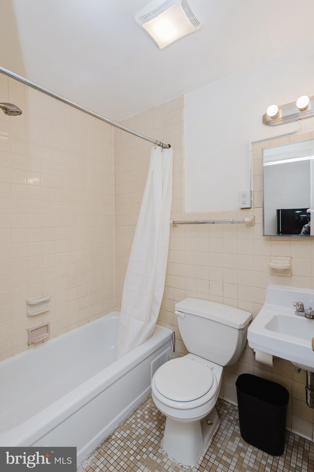 2318 South Broad Street Philadelphia, PA 19145 - Photo 22 of 28 a white toilet sitting next to a bath tub