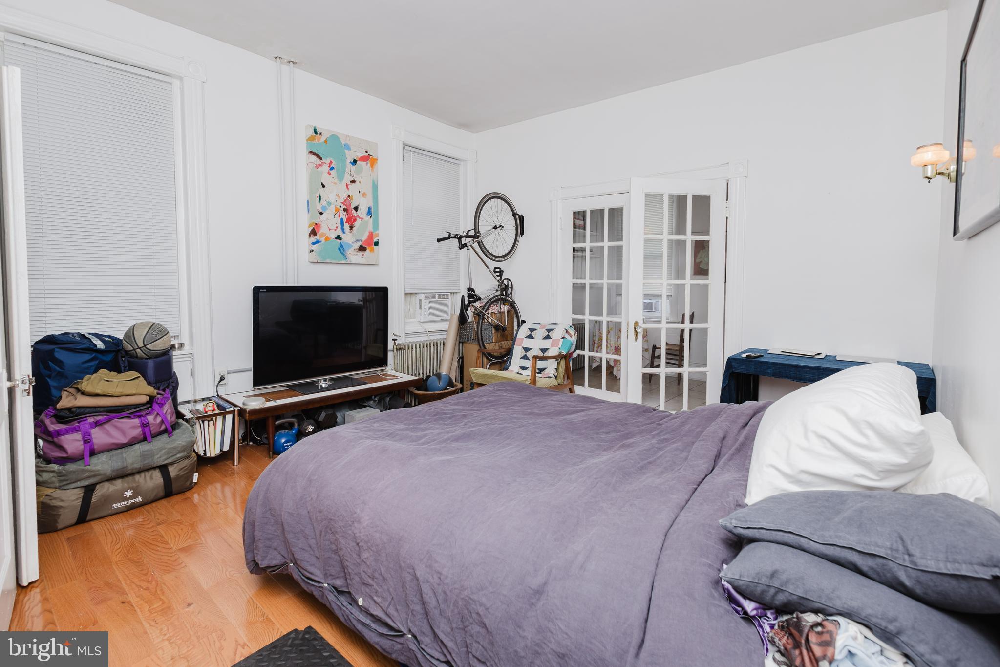 2318 South Broad Street Philadelphia, PA 19145 - Photo 9 of 28 a bedroom with furniture and a flat screen tv