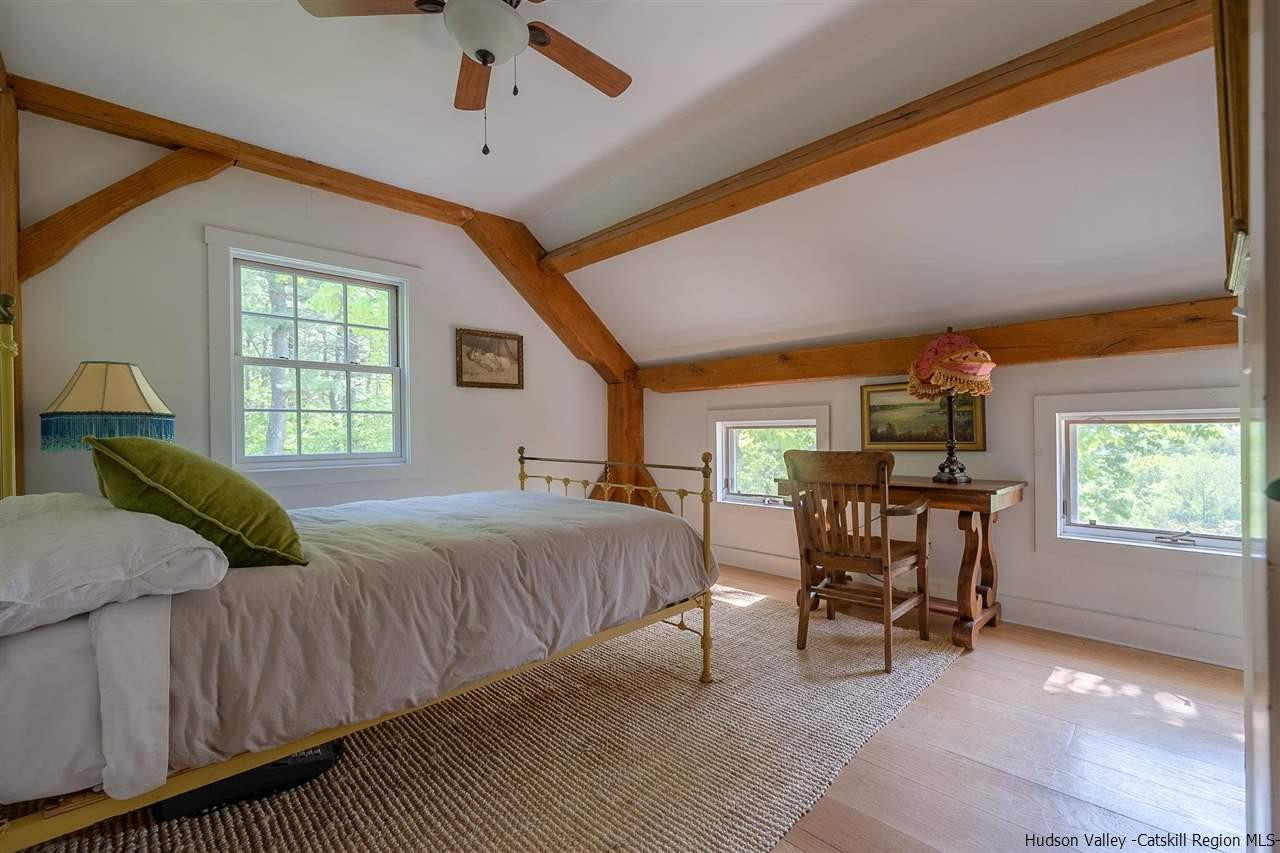 306 Thielman Road Hudson, NY 12534 - Photo 12 of 35 a bedroom with a bed and a chandelier