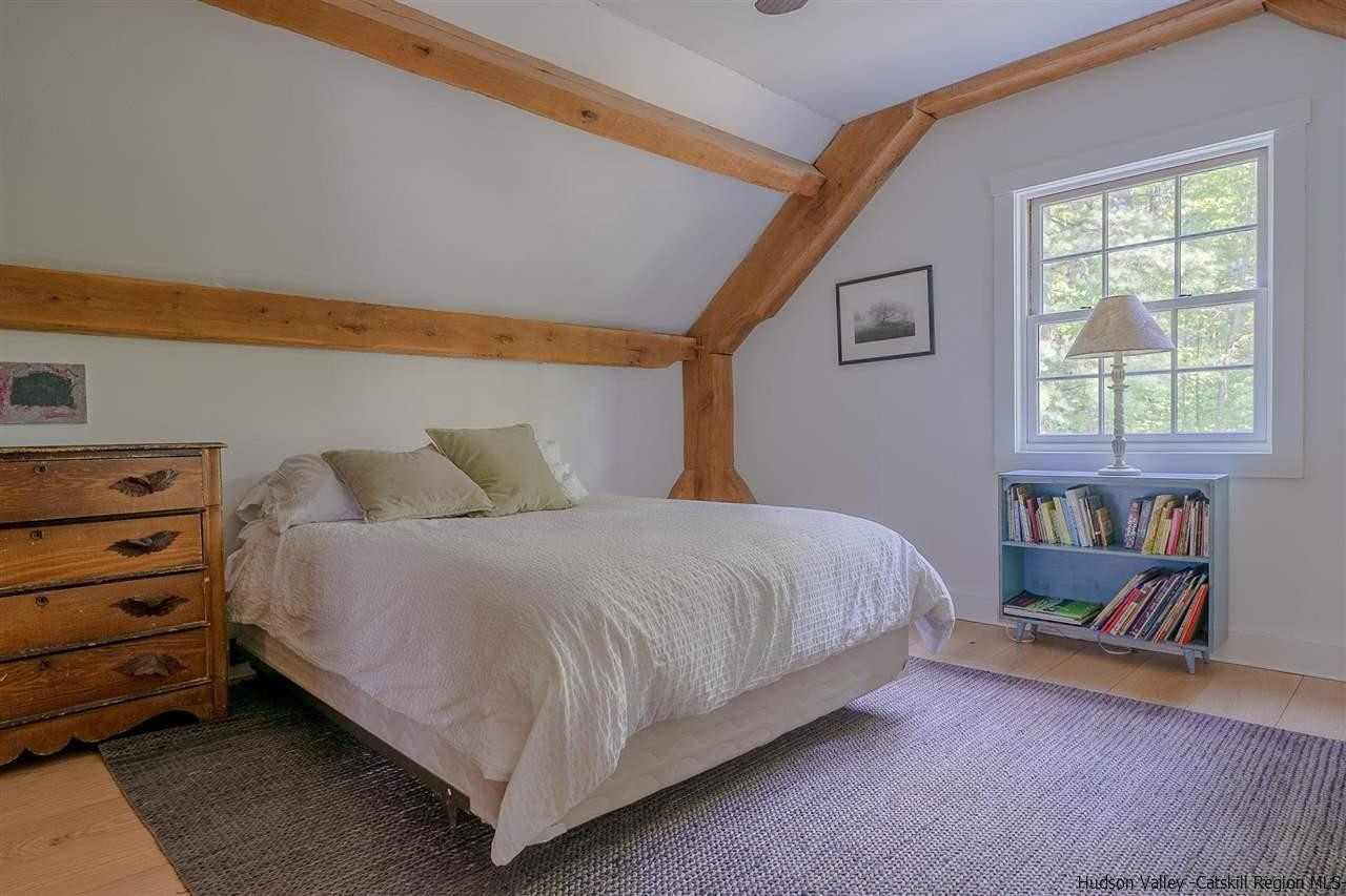 306 Thielman Road Hudson, NY 12534 - Photo 13 of 35 a bed sitting in a bedroom next to a window