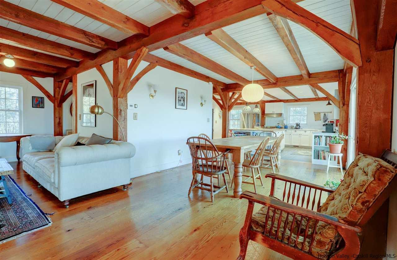 306 Thielman Road Hudson, NY 12534 - Photo 25 of 35 a dining room with furniture wooden floor and a potted plant