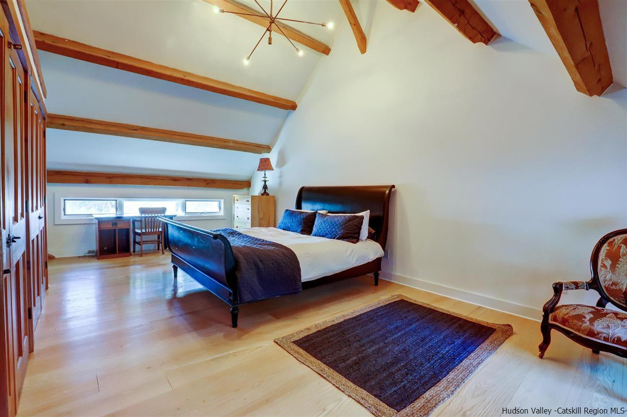 306 Thielman Road Hudson, NY 12534 - Photo 9 of 35 a bedroom with a bed and wooden floor