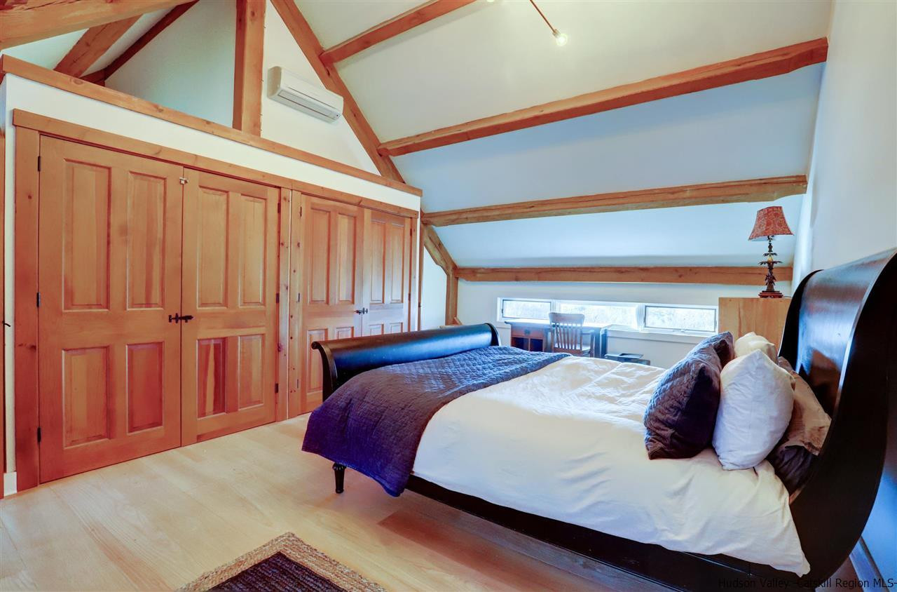 306 Thielman Road Hudson, NY 12534 - Photo 10 of 35 a bedroom with a bed and wooden floor