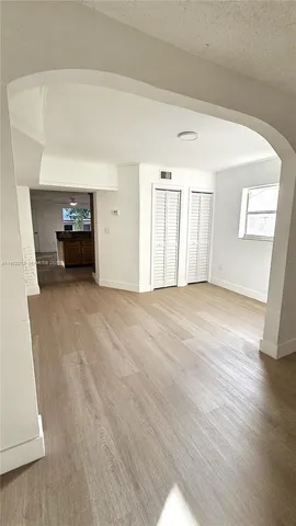 a view of a livingroom with wooden floor and staircase