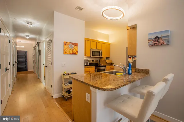 a view of a kitchen area with furniture and wooden floor