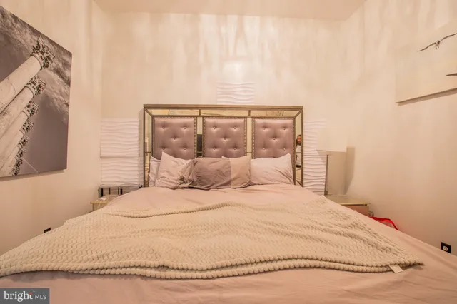 a large white bed in a white room
