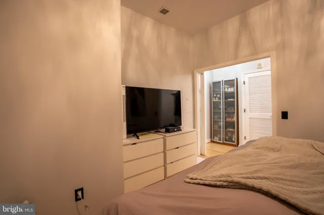 a bedroom with a bed and a flat screen tv