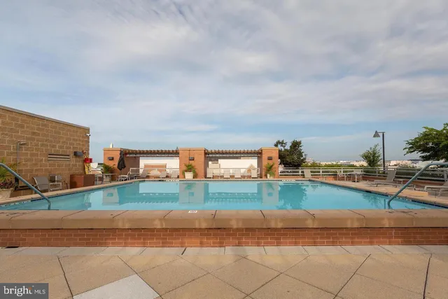 a view of a hallway with wooden floor and a living room