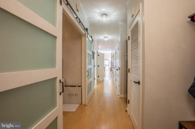a view of a hallway with wooden floor and staircase