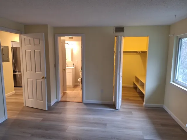 an empty room with wooden floor and a window