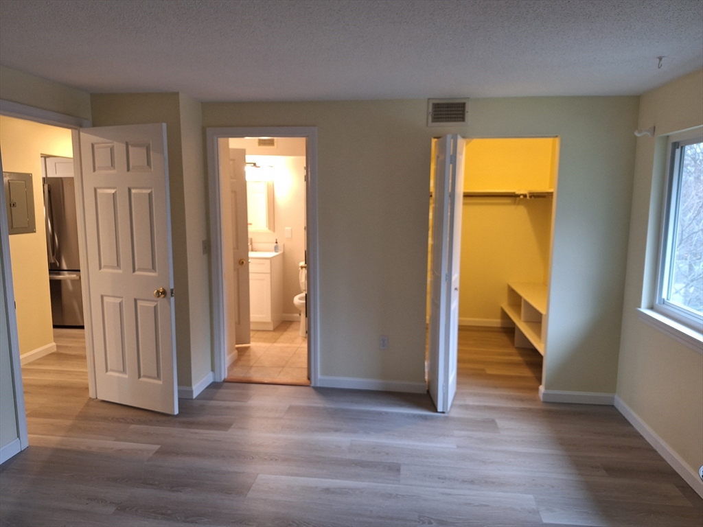 10 Beal's Cove Road, Unit C Hingham, MA 02043 - Photo 6 of 10 an empty room with wooden floor and a window