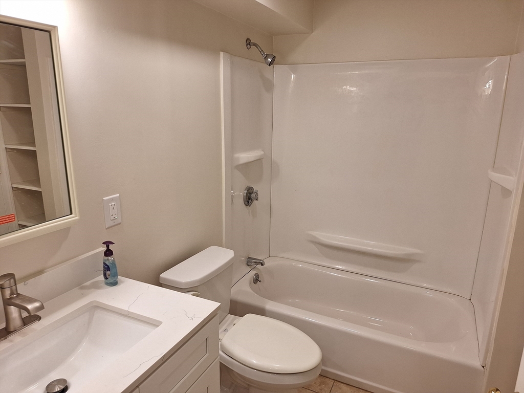 10 Beal's Cove Road, Unit C Hingham, MA 02043 - Photo 7 of 10 a bathroom with a sink a toilet and shower