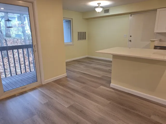 a room with a bed and wooden floor