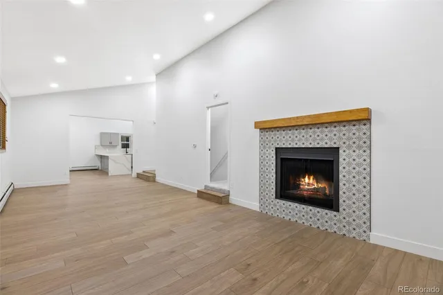a view of an empty room with a fireplace