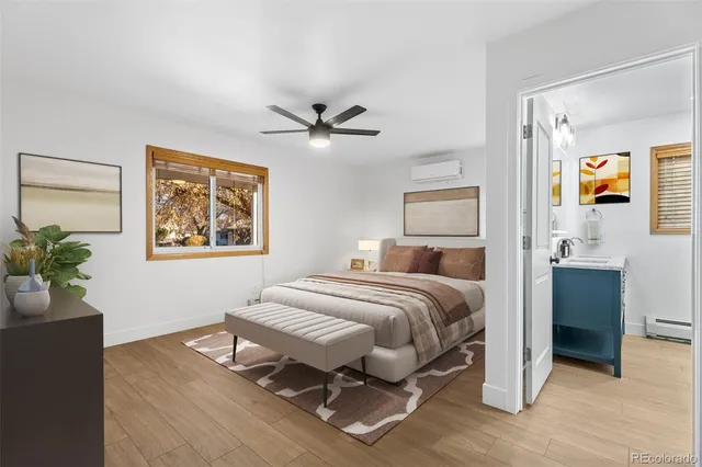 a spacious bedroom with a bed and a chandelier