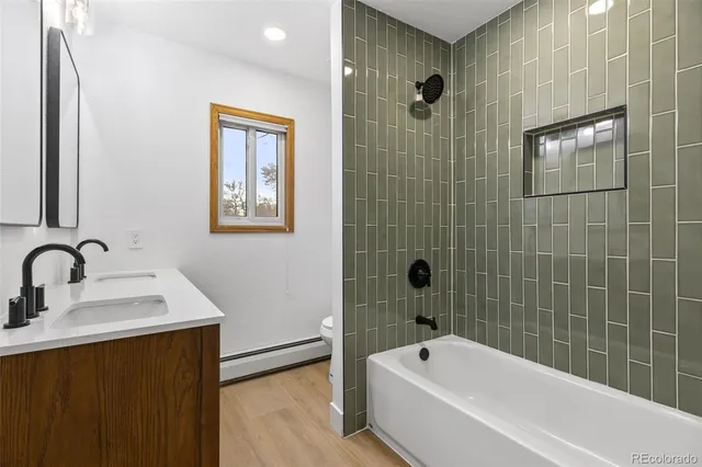 a bathroom with a bathtub a shower a sink and mirror