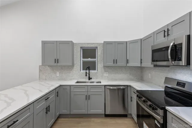 a kitchen with a sink stove and microwave