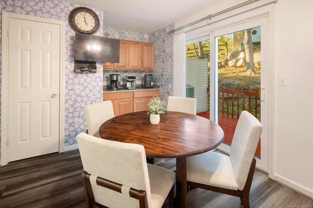 a dining room with furniture a window and wooden floor