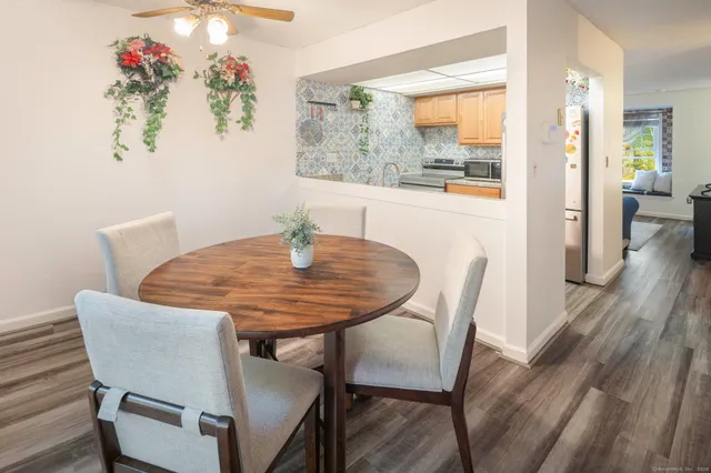 a dining room with furniture and wooden floor