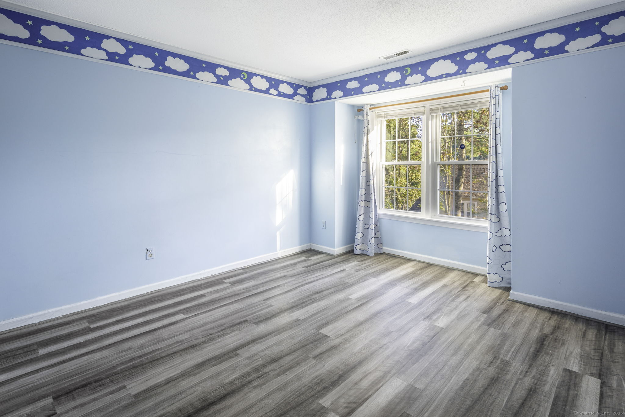 380 Hitchcock Road, Unit 48 Waterbury, CT 06705 - Photo 17 of 28 a view of an empty room with wooden floor and a window