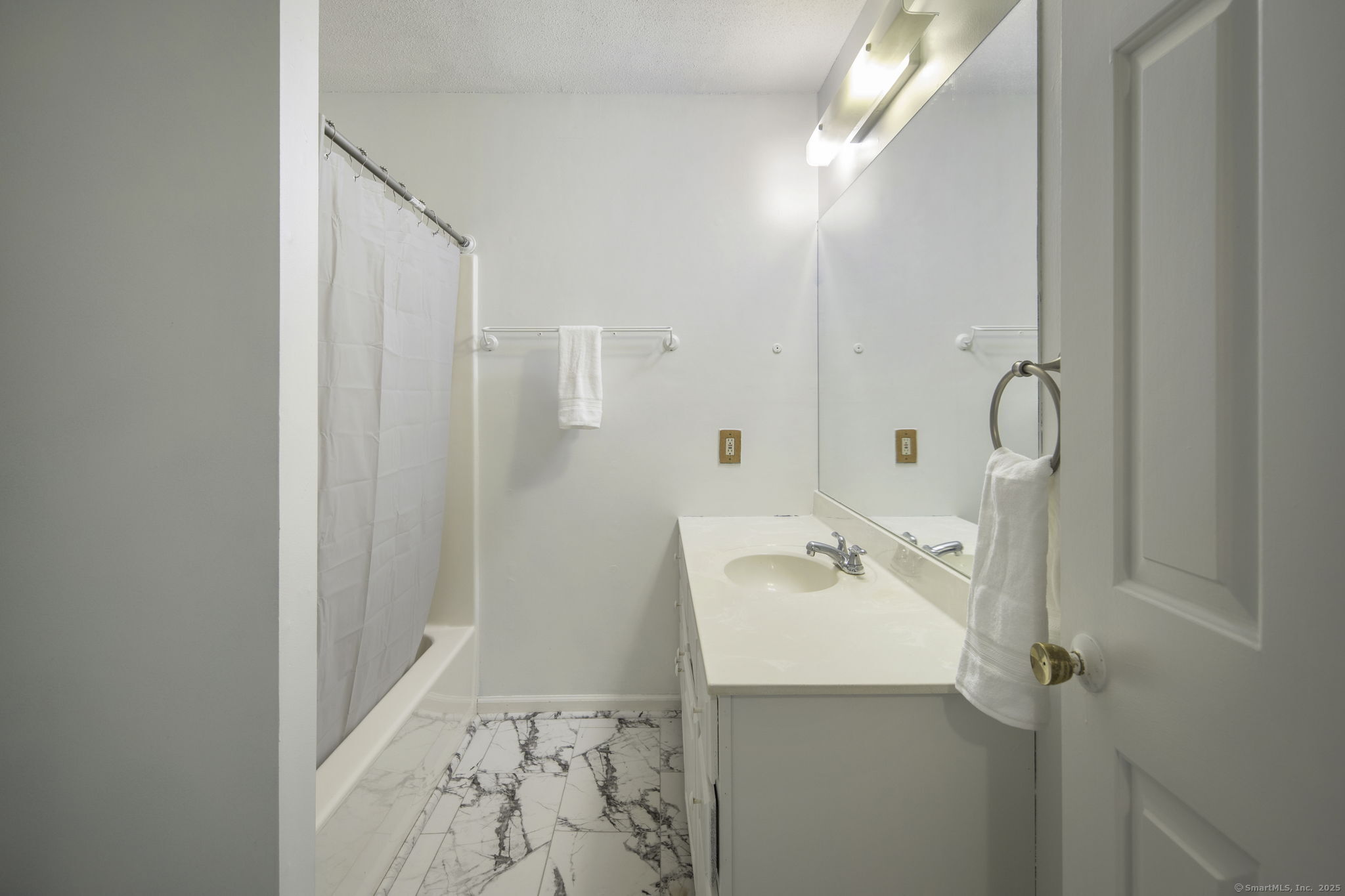 380 Hitchcock Road, Unit 48 Waterbury, CT 06705 - Photo 20 of 28 a bathroom with a sink a mirror and shower