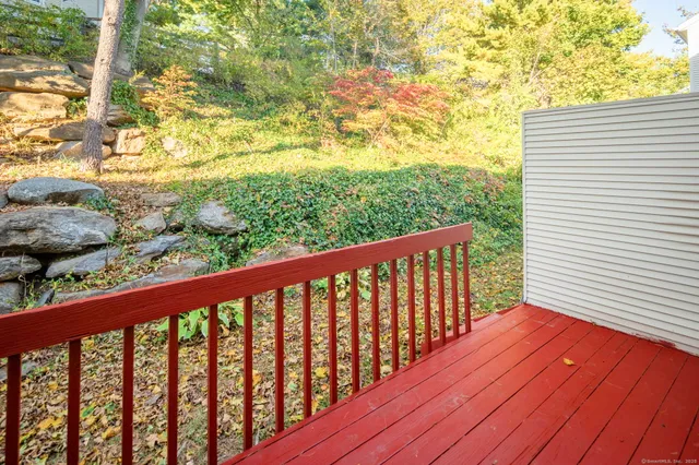 a balcony with wooden floor and fence