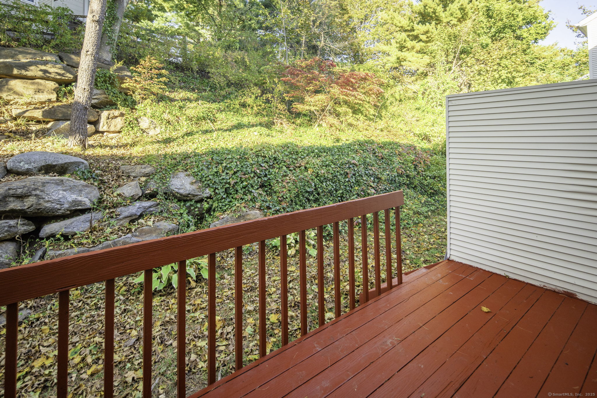 380 Hitchcock Road, Unit 48 Waterbury, CT 06705 - Photo 22 of 28 a balcony with wooden floor and fence