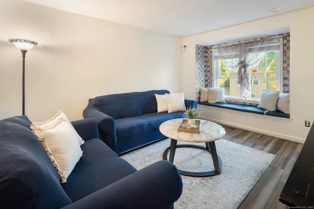 a living room with furniture and a large window