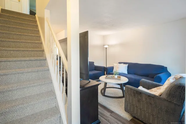 a living room with furniture and a lamp