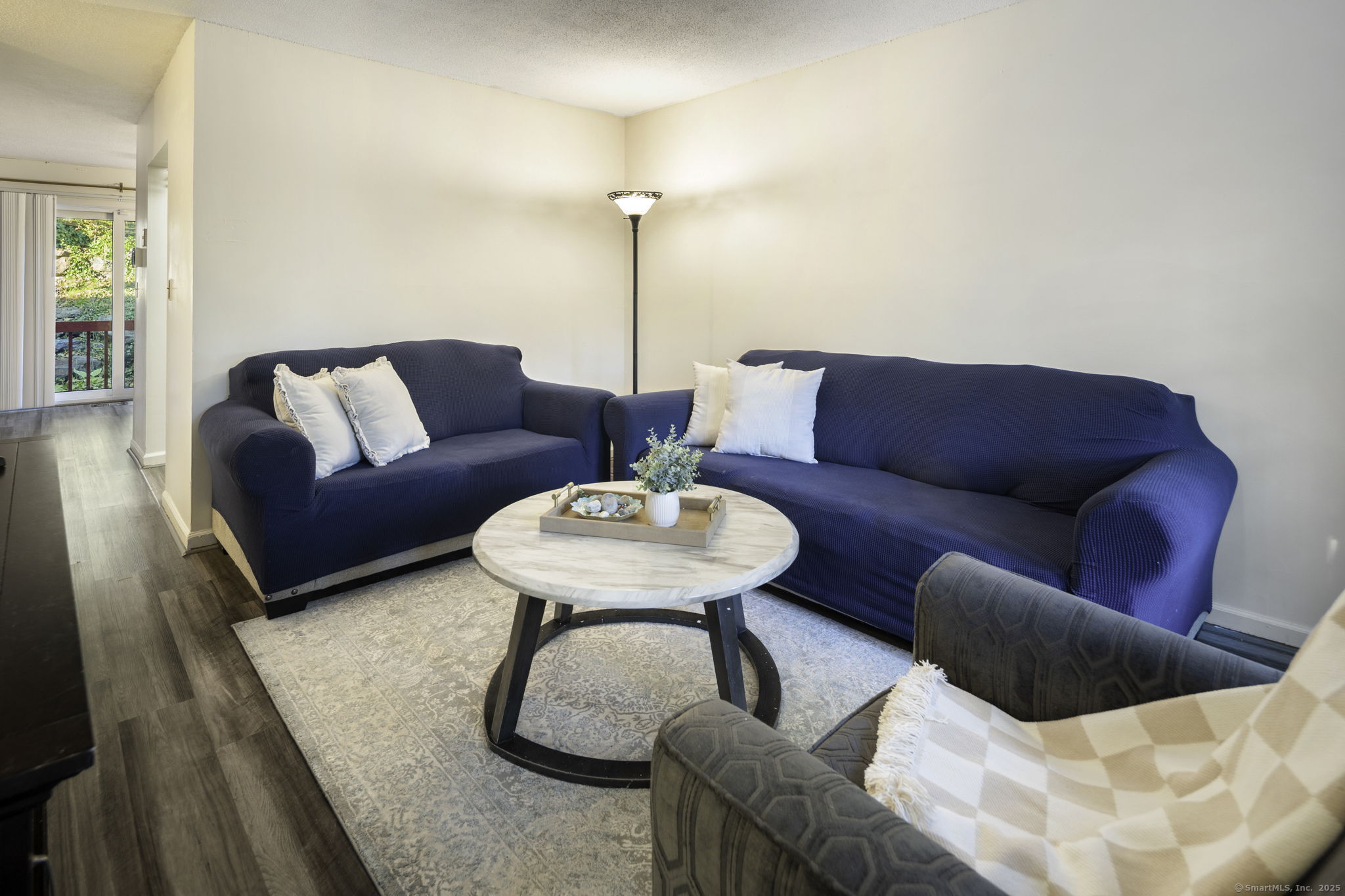 380 Hitchcock Road, Unit 48 Waterbury, CT 06705 - Photo 9 of 28 a living room with furniture and a wooden floor