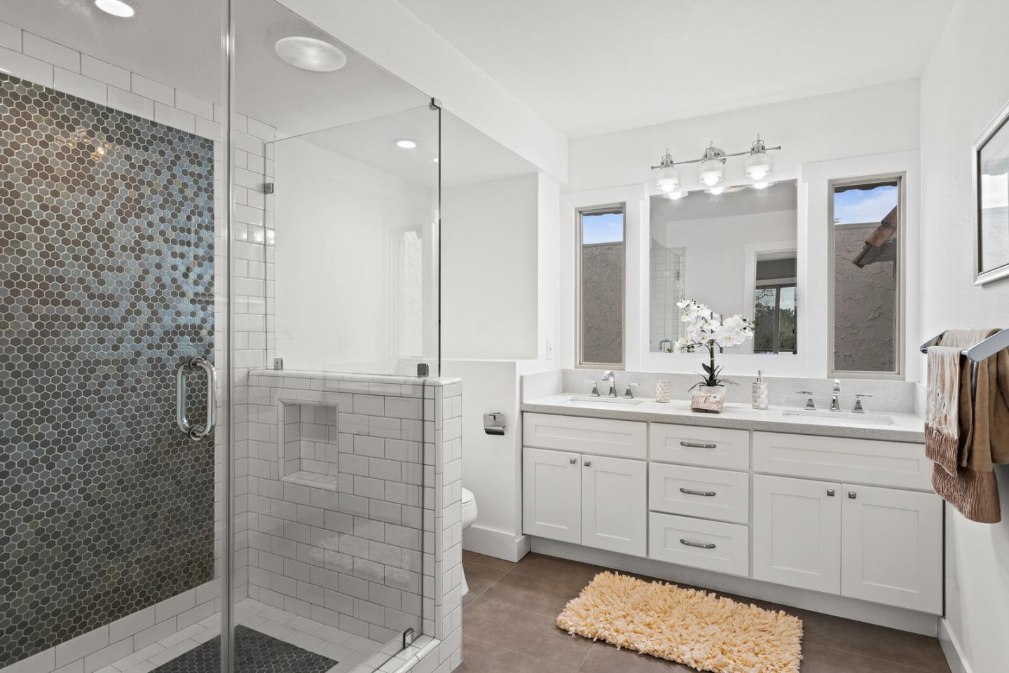 5 Rinconada Circle Belmont, CA 94002 - Photo 12 of 24 a bathroom with a double vanity sink mirror and shower