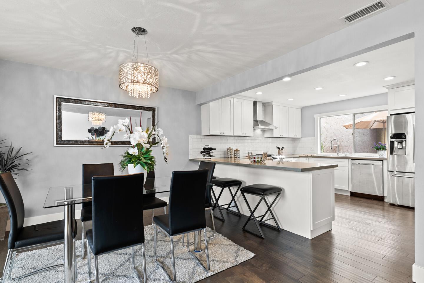 5 Rinconada Circle Belmont, CA 94002 - Photo 3 of 24 a view of a dining room with furniture a chandelier and wooden floor