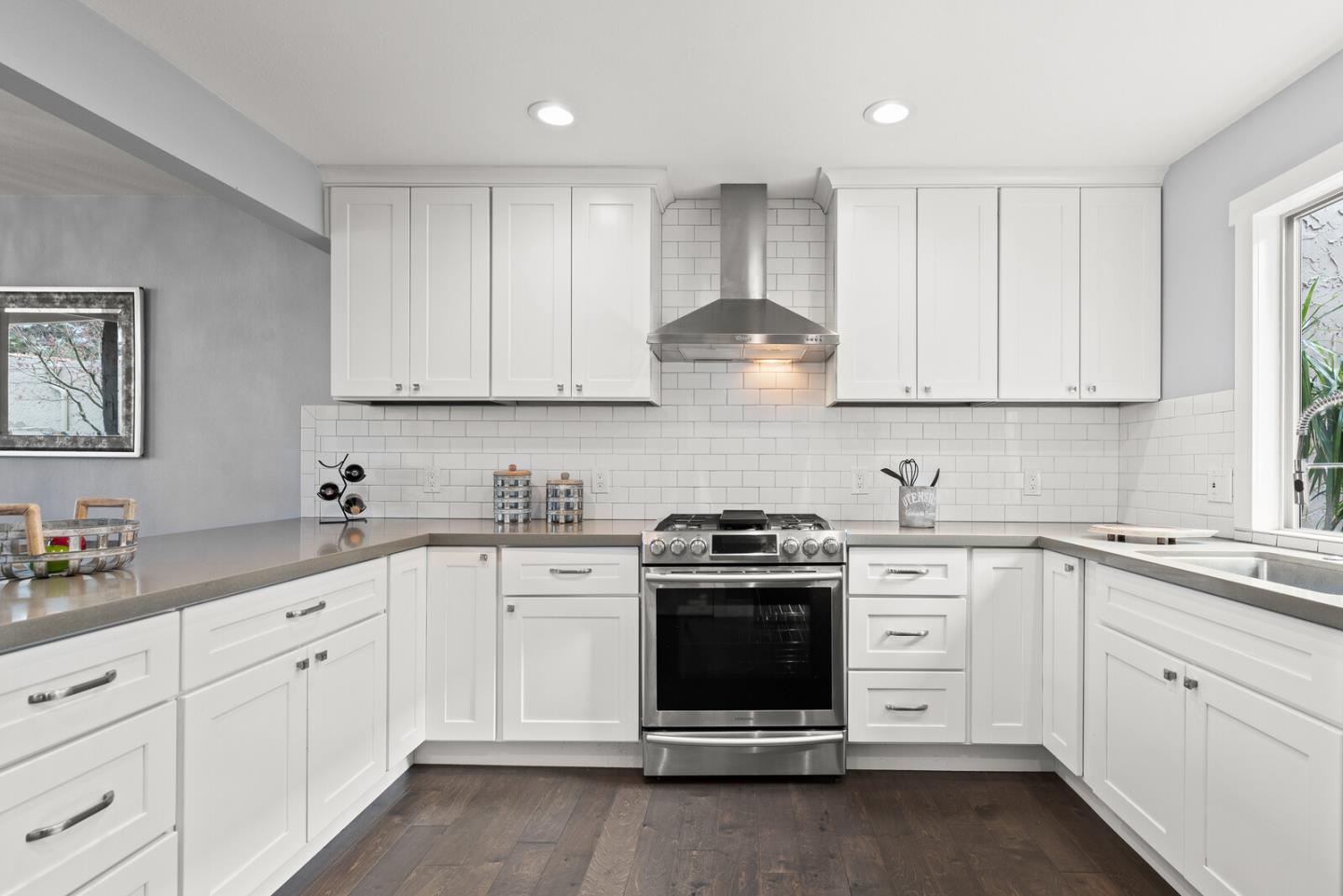 5 Rinconada Circle Belmont, CA 94002 - Photo 4 of 24 a kitchen with white cabinets stainless steel appliances and sink