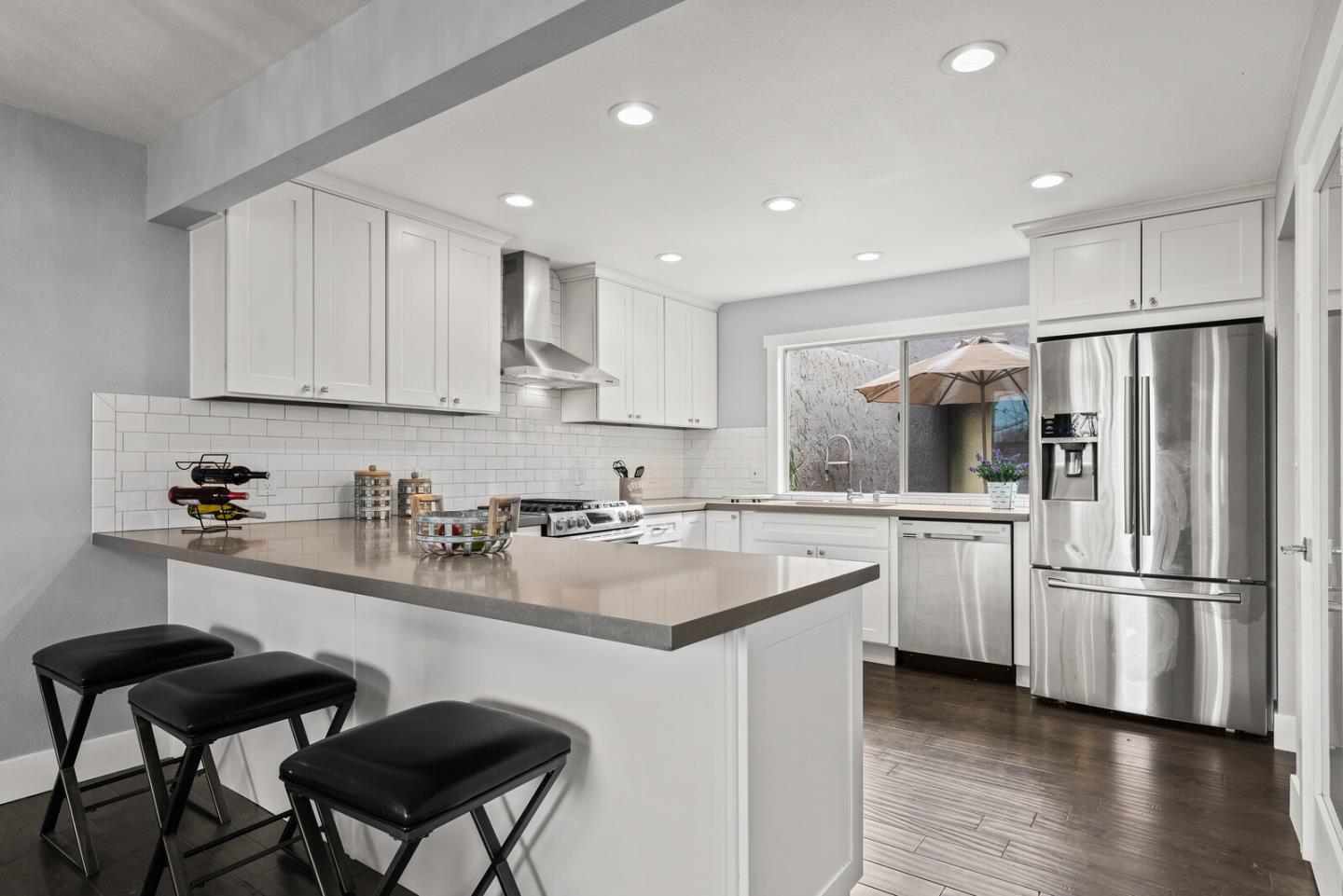5 Rinconada Circle Belmont, CA 94002 - Photo 5 of 24 a kitchen with a refrigerator a sink and cabinets