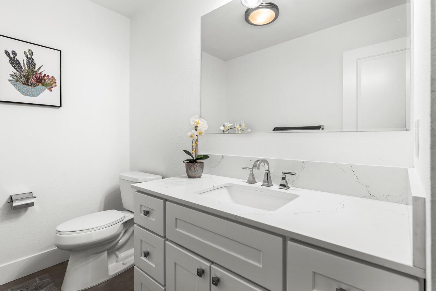 5 Rinconada Circle Belmont, CA 94002 - Photo 10 of 24 a bathroom with a toilet sink and mirror