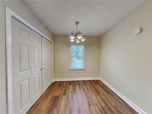 a view of wooden floor and windows in a room