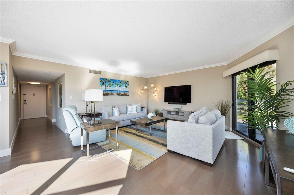 1050 Longboat Club Road, Unit 204 Longboat Key, FL 34228 - Photo 13 of 64 a living room with furniture and a flat screen tv