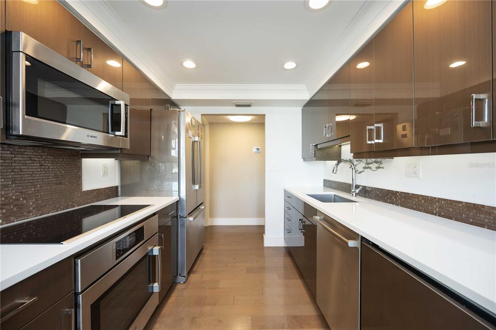 1050 Longboat Club Road, Unit 204 Longboat Key, FL 34228 - Photo 21 of 64 a kitchen with stainless steel appliances granite countertop a sink and a microwave