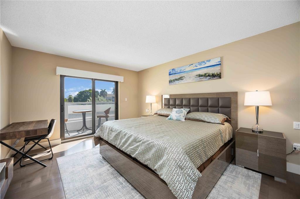 1050 Longboat Club Road, Unit 204 Longboat Key, FL 34228 - Photo 25 of 64 a bedroom with a large bed and a window