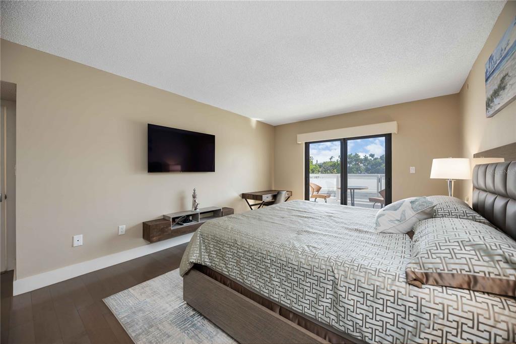 1050 Longboat Club Road, Unit 204 Longboat Key, FL 34228 - Photo 26 of 64 a bedroom with a bed and a flat screen tv