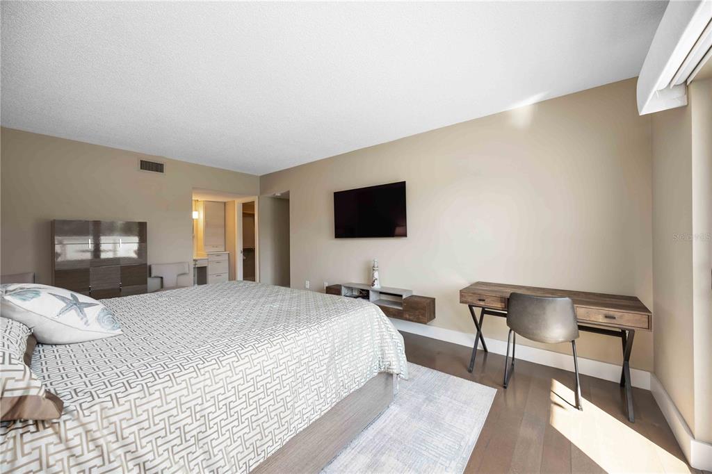 1050 Longboat Club Road, Unit 204 Longboat Key, FL 34228 - Photo 27 of 64 a bedroom with a bed and a flat screen tv