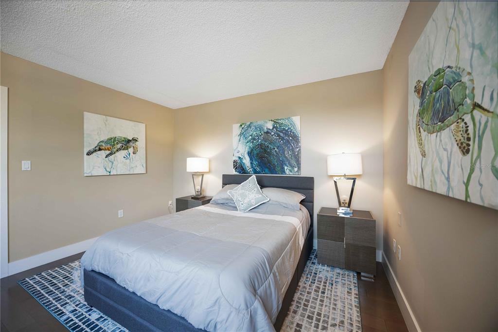 1050 Longboat Club Road, Unit 204 Longboat Key, FL 34228 - Photo 32 of 64 a bedroom with a bed and a painting on the wall