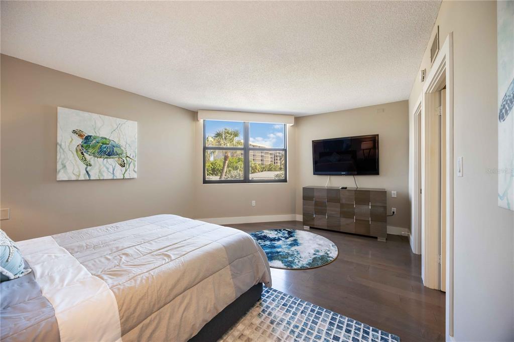 1050 Longboat Club Road, Unit 204 Longboat Key, FL 34228 - Photo 34 of 64 a bedroom with a bed and a flat screen tv