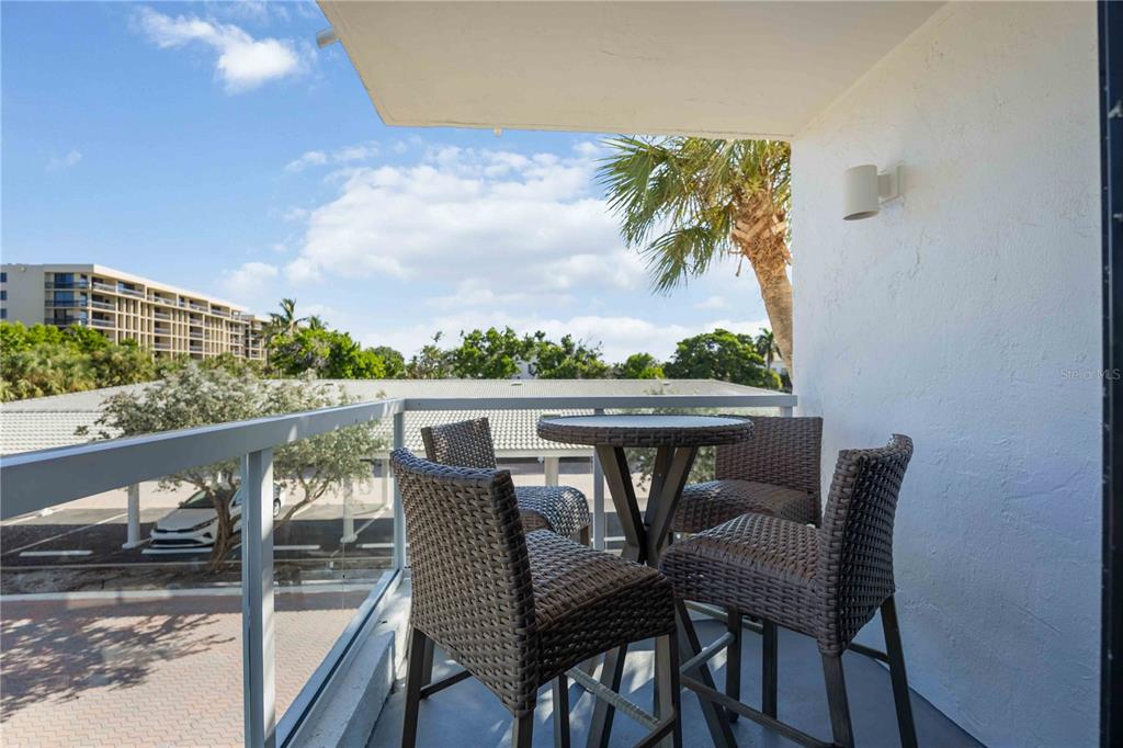 1050 Longboat Club Road, Unit 204 Longboat Key, FL 34228 - Photo 38 of 64 a view of a chairs and table on the balcony