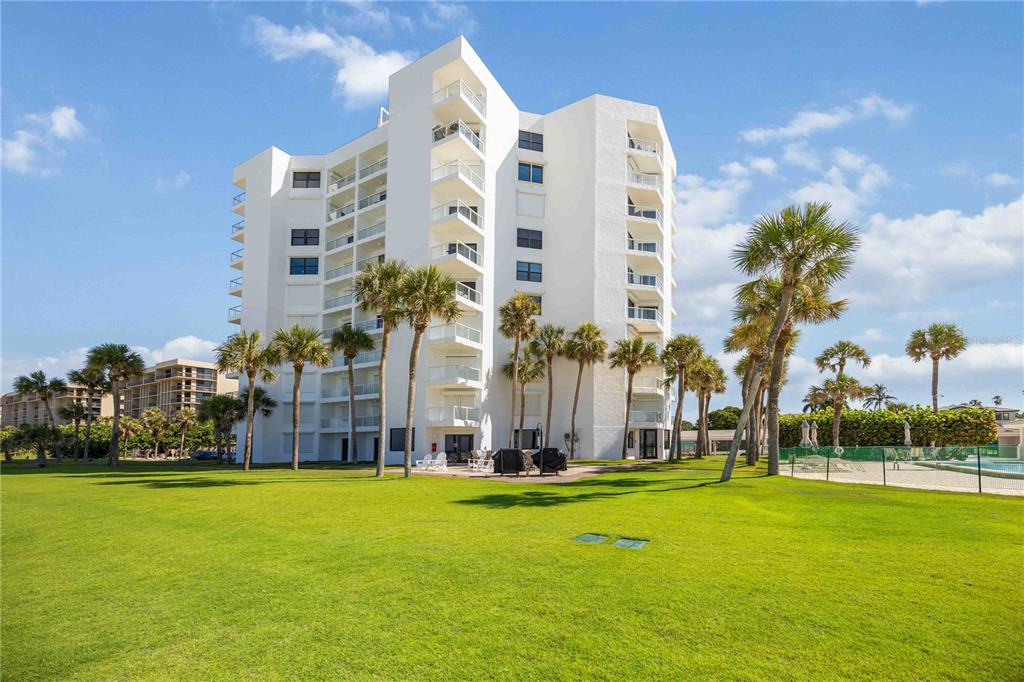1050 Longboat Club Road, Unit 204 Longboat Key, FL 34228 - Photo 47 of 64 a multi story building with trees in front of it