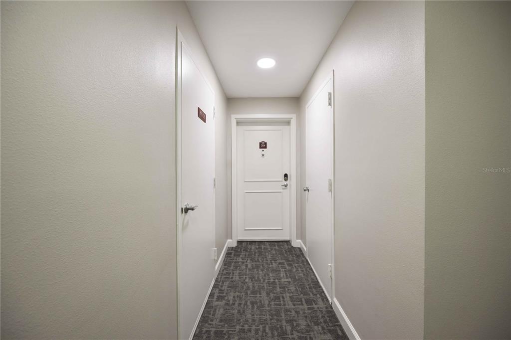 1050 Longboat Club Road, Unit 204 Longboat Key, FL 34228 - Photo 9 of 64 a view of a hallway with wooden floor